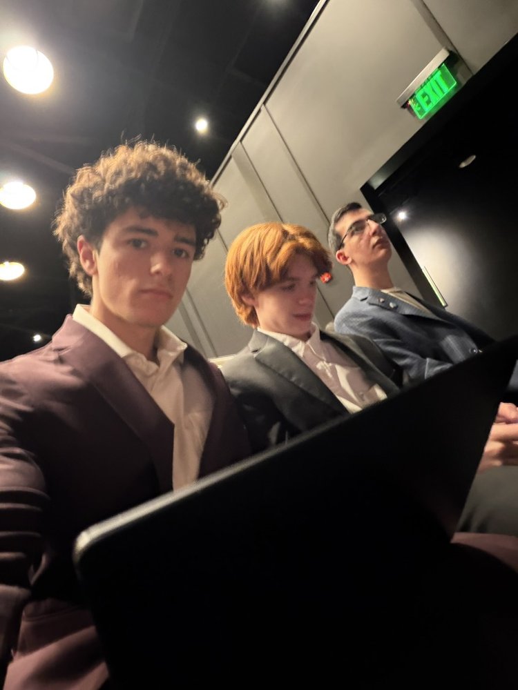 Ryan editing on a laptop in an award show audience
